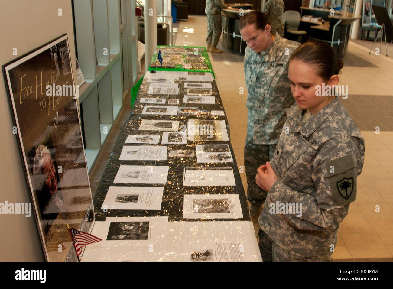 U.S. Army Staff Sgt. Leslie Krause (left) and Spc. Rachel Clark soldiers assigned to the South Carolina National Guard, look at displays during the black history month celebration at McEntire Joint National Guard, Feb. 27, 2014. The event was hosted by the joint diversity execute council, special presentations were given by Horrill Hill Elementary, Youth Challenge Academy and the guest speaker U.S. Army Lt. Col. Evet H. Jefferson, mobilization readiness division chief for the SCARNG.  (U.S. Air National Guard photo by Tech. Sgt. Jorge Intriago/Released) Stock Photo