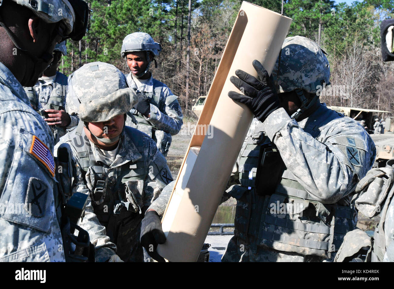 Sgt. 1st Class Christopher Jiles, platoon sergeant,  Sgt. Fabian Gutierrez, ammuntition sergeant, and Spc. Jovon Cauthen, #1 cannonier,  with the 178th Field Artillery Battalion, A Battery, South Carolina Army National Guard, inspect ammunitions powder before distribution during their annual training on the firing ranges at Fort Stewart, GA. The 178th focus for training is on manual gunnery, a skill seldom used with today’s technology, but very important for when computers go down and technology doesn't work. (U.S. Army National Guard photo by OC Tracci Dorgan/Released) Stock Photo