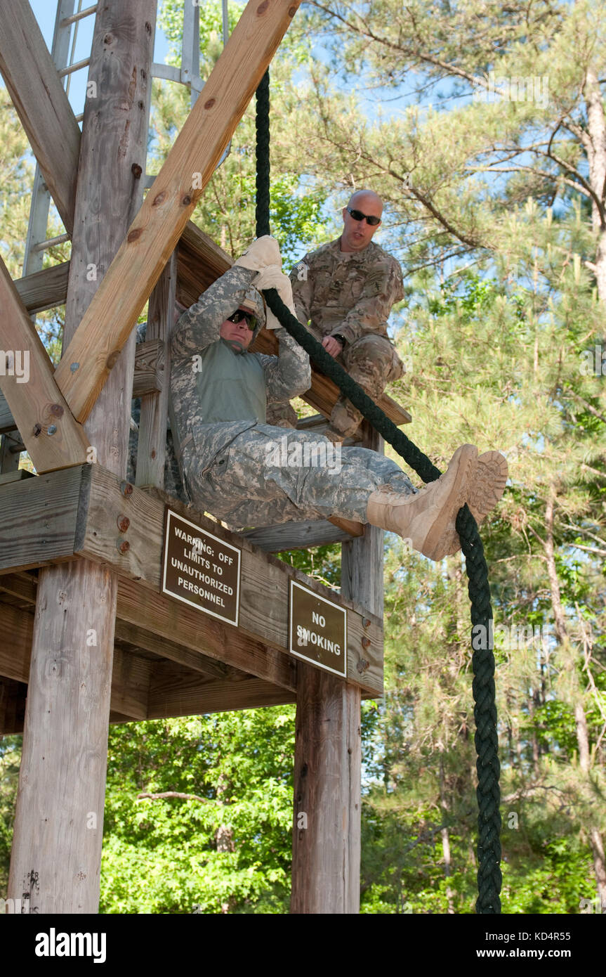 A South Carolina Army National Guard Soldier assigned to 4th Battalion, 118th Infantry Regiment, 218th Maneuver Enhancement Brigade holds himself stationary during Fast Rope Insertion Exfiltration System (FRIES) training at McCrady Training Center, Eastover, S.C., May 17, 2014. Soldiers from 7th Special Forces Group (Airborne), trained approximately 100 4-118th IN BN Soldiers on the proper FRIES technique over the course of the weekend. (U.S. Army National Guard photo by Sgt. 1st Class Kimberly D. Calkins/Released) Stock Photo
