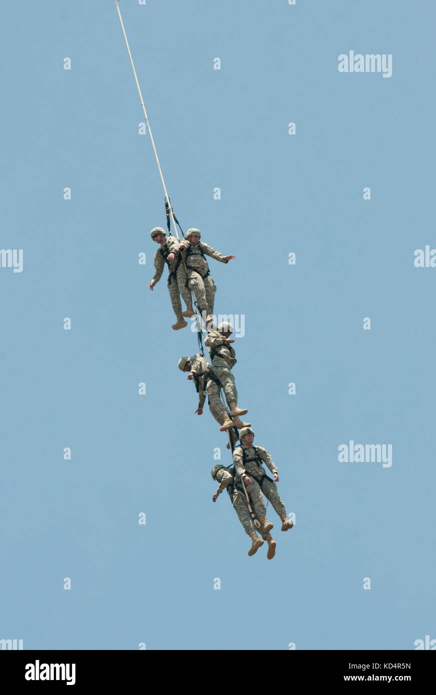 Six U.S. Army Soldiers assigned to 4th Battalion, 118th Infantry Regiment, South Carolina Army National Guard, fly through the air while tethered from an MH47G Chinook provided by the 160th Special Operations Aviation Regiment (Airborne) during Special Insertion Exfiltration System training at McCrady Training Center, Eastover, S.C., May 17, 2014.  The 160th SOAR (A) supported a joint mission with 7th Special Forces Group (Airborne) training over 100 Soldiers assigned to 4th Battalion, 118th Infantry Regiment, South Carolina Army National Guard during drill weekend. (U.S. Army National Guard p Stock Photo