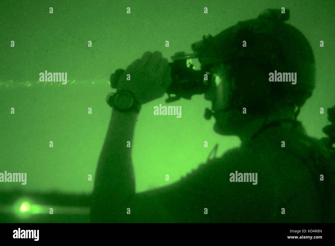 A U.S. Air Force Joint Terminal Attack Controller assigned to the 22nd Special Tactics Squadron uses a laser to designate a target for aircraft overhead at Poinsett Electronic Combat Range on Shaw Air Force Base, S.C., May 21, 2014.  Elements of the South Carolina Army and Air National Guard, U.S. Army and U.S. Air Force special operations, and Columbia Police Department S.W.A.T., conducted nighttime training, which allowed special operations forces and the National Guard to conduct joint urban assault training. (U.S. Army National Guard photo by Sgt. Brian Calhoun/Released) Stock Photo