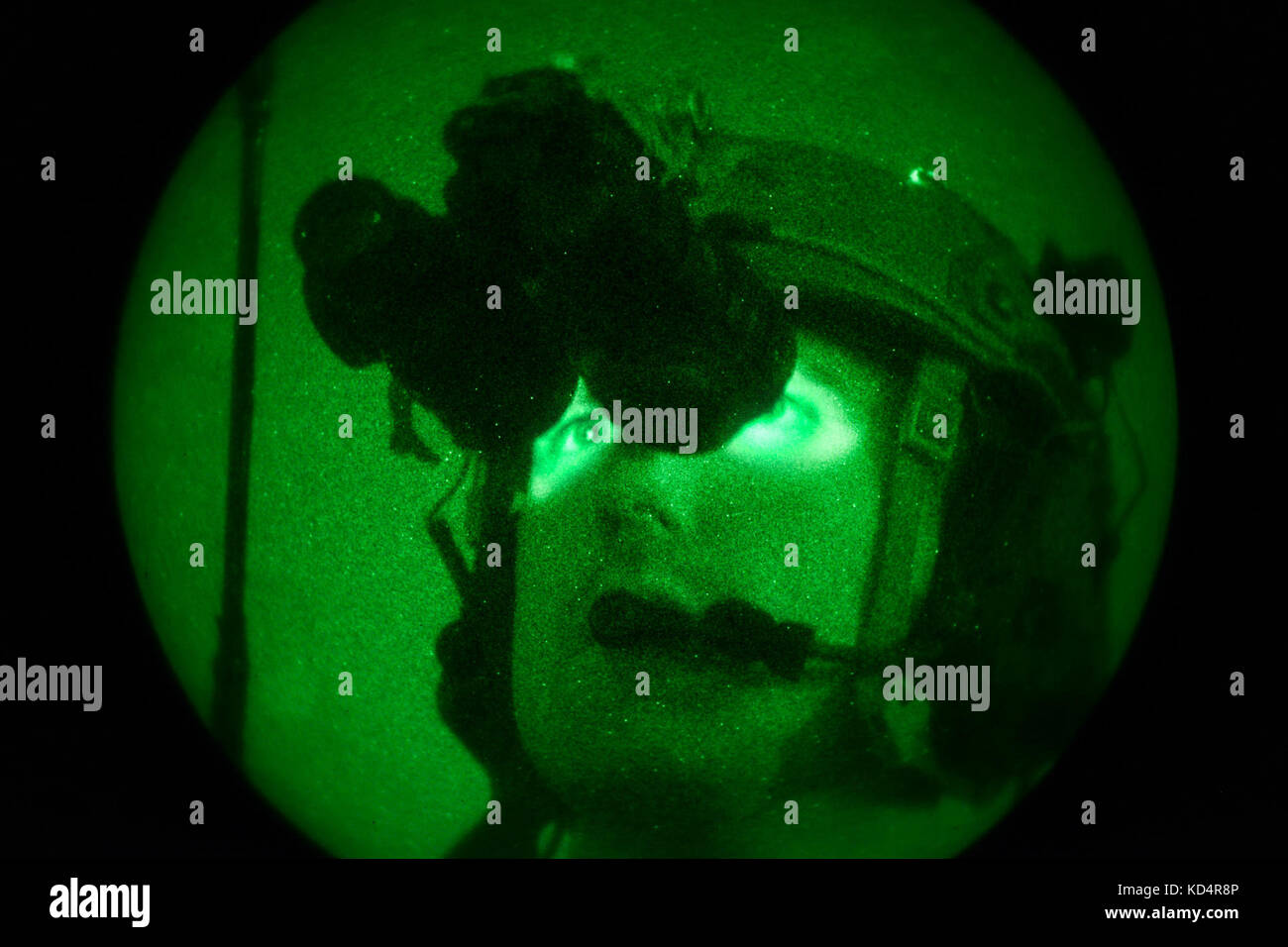 A U.S. Air Force Joint Terminal Attack Controller assigned to the 22nd Special Tactics Squadron looks through his night vision as he conducts close air support operations at Poinsett Electronic Combat Range on Shaw Air Force Base, S.C., May 21, 2014.  Elements of the South Carolina Army and Air National Guard, U.S. Army and U.S. Air Force special operations, and Columbia Police Department S.W.A.T., conducted nighttime training, which allowed special operations forces and the National Guard to conduct joint urban assault training. (U.S. Air National Guard photo by Tech. Sgt. Jorge Intriago/Rele Stock Photo