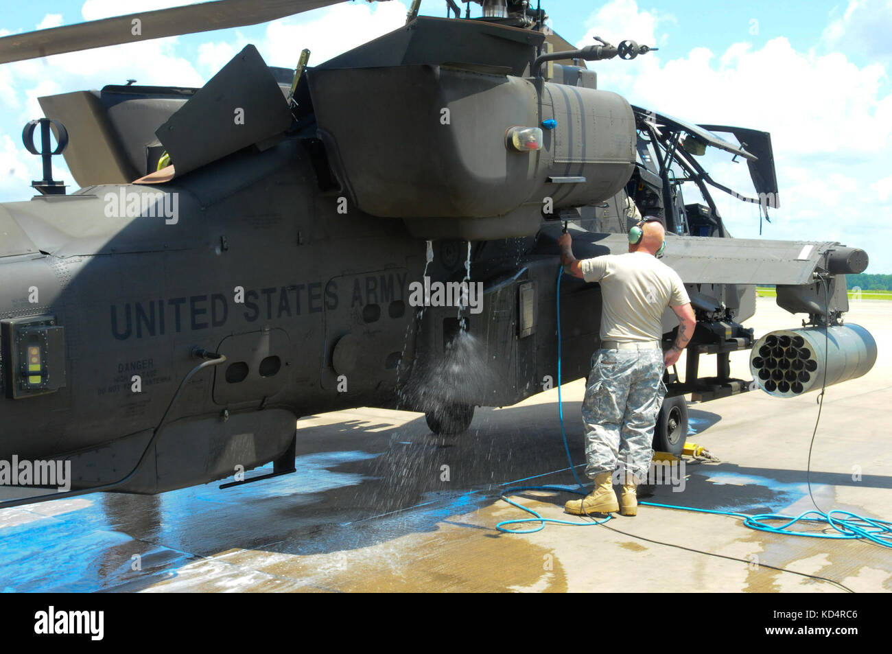 Soldiers from the 1-151 Attack Reconnaissance Battalion, South Carolina Army National Guard, perform preventative maintenance on a U.S. Army AH-64D Apache by washing the aircraft’s turbines engines at McEntire Joint National Guard Base on July 12, 2014. A sprayer-nozzle attached to the gas turbine engine injects hot soapy water into the engines to remove debris and carbon build-up. (U.S. Army National Guard photo by Brian Calhoun/Released) Stock Photo