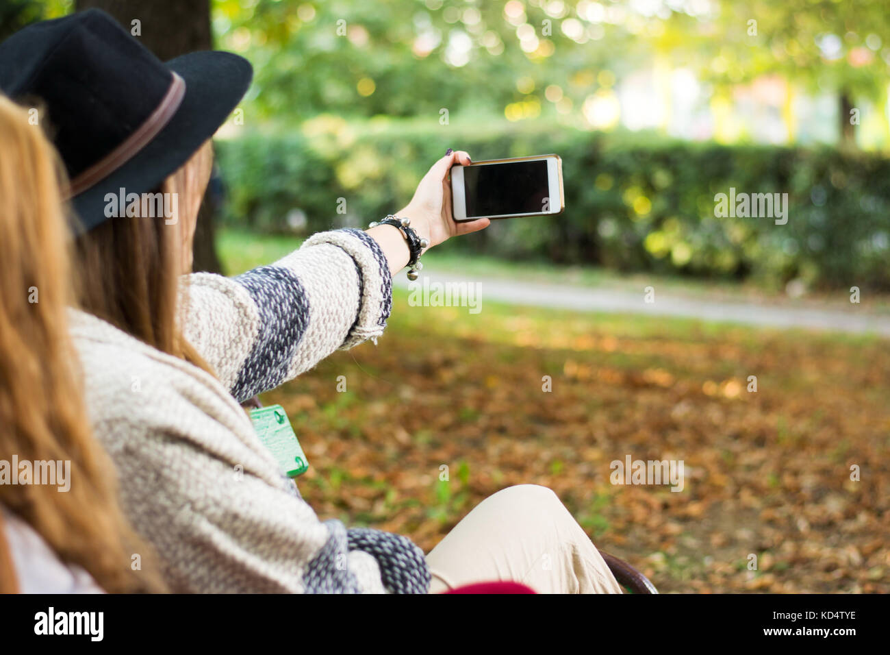 Two girlfriends taking selfie in the park Stock Photo