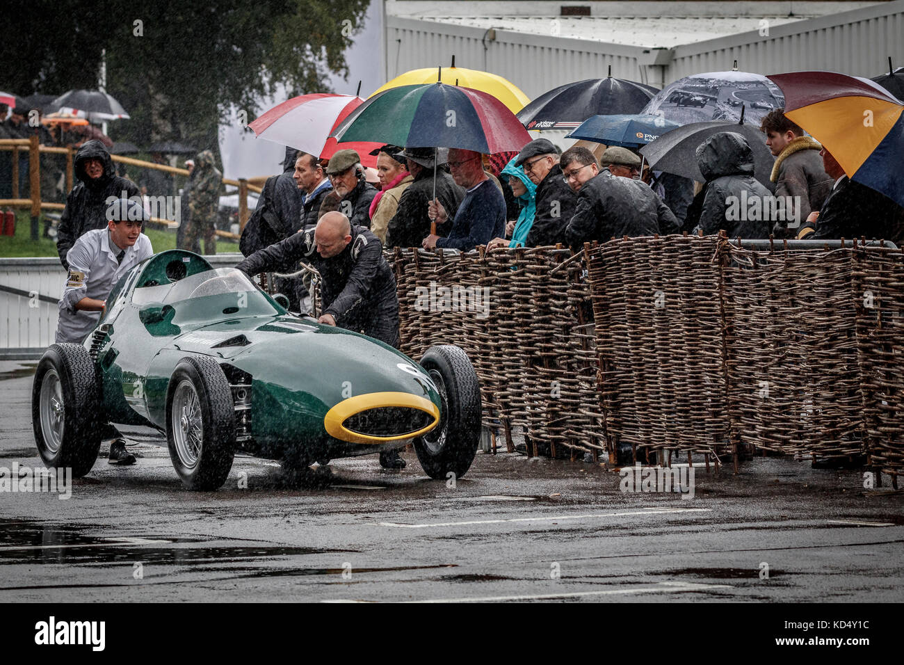 1957 Vanwall F1 car is pushed into the paddock from the British 1957 Grand Prix Celebration with heavy rain, at the 2017 Goodwood Revival, Sussex, UK. Stock Photo