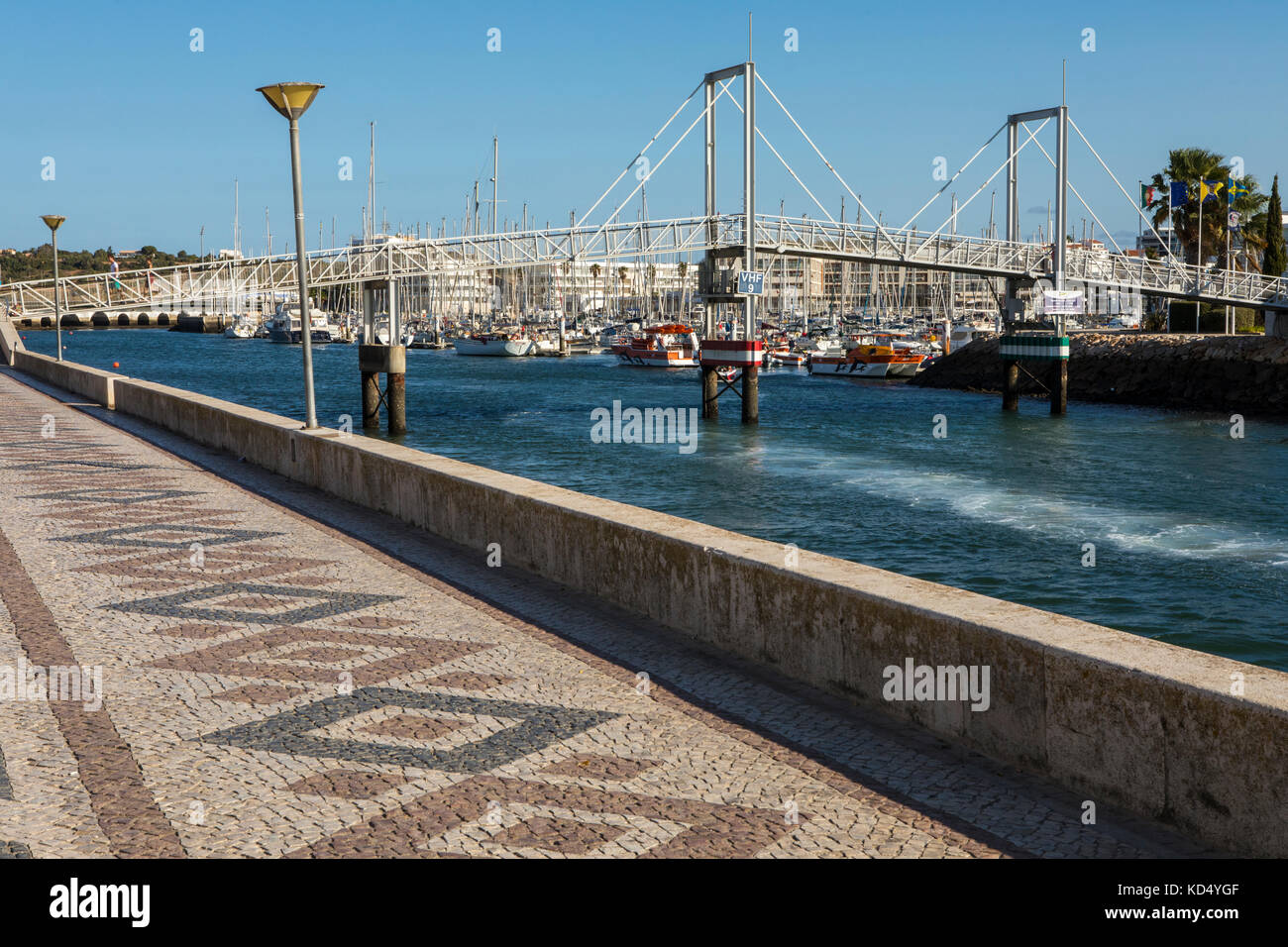 LAGOS, PORTUGAL - SEPTEMBER 10TH 2017: A view of the pedestrian drawbridge at the Marina de Lagos in the Algarve, Portugal, on 10th September 2017. Stock Photo