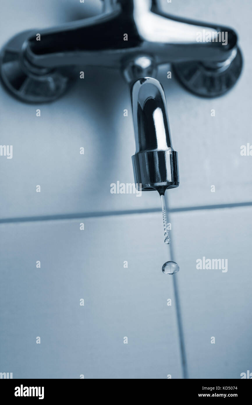 Faucet or kitchen tap leaking with water drops. Saving water concept