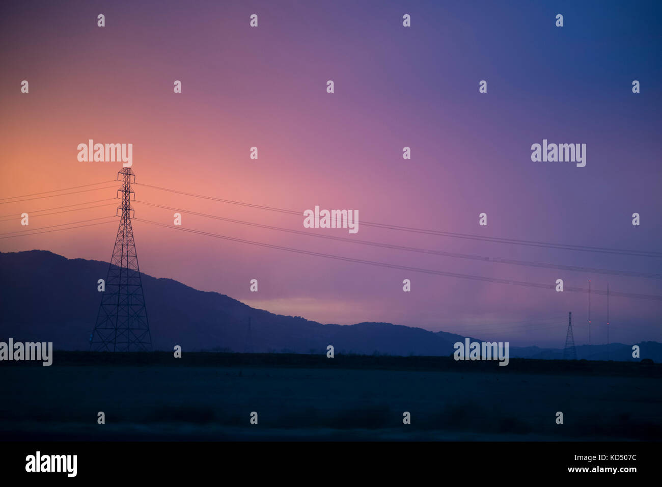 A cross-country power supply line during sunset Stock Photo - Alamy