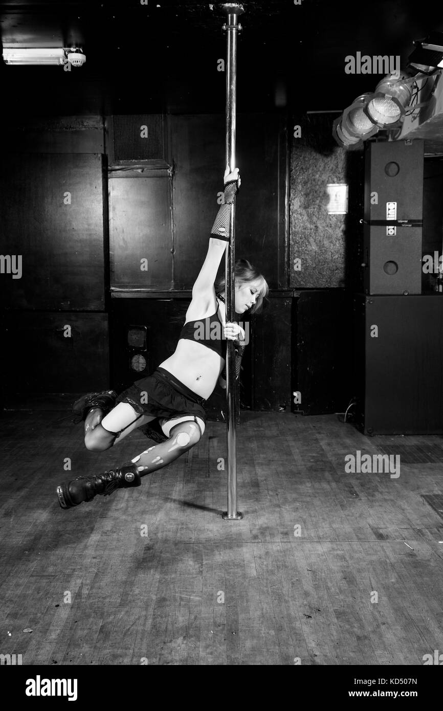 Girl in all black club pole dance