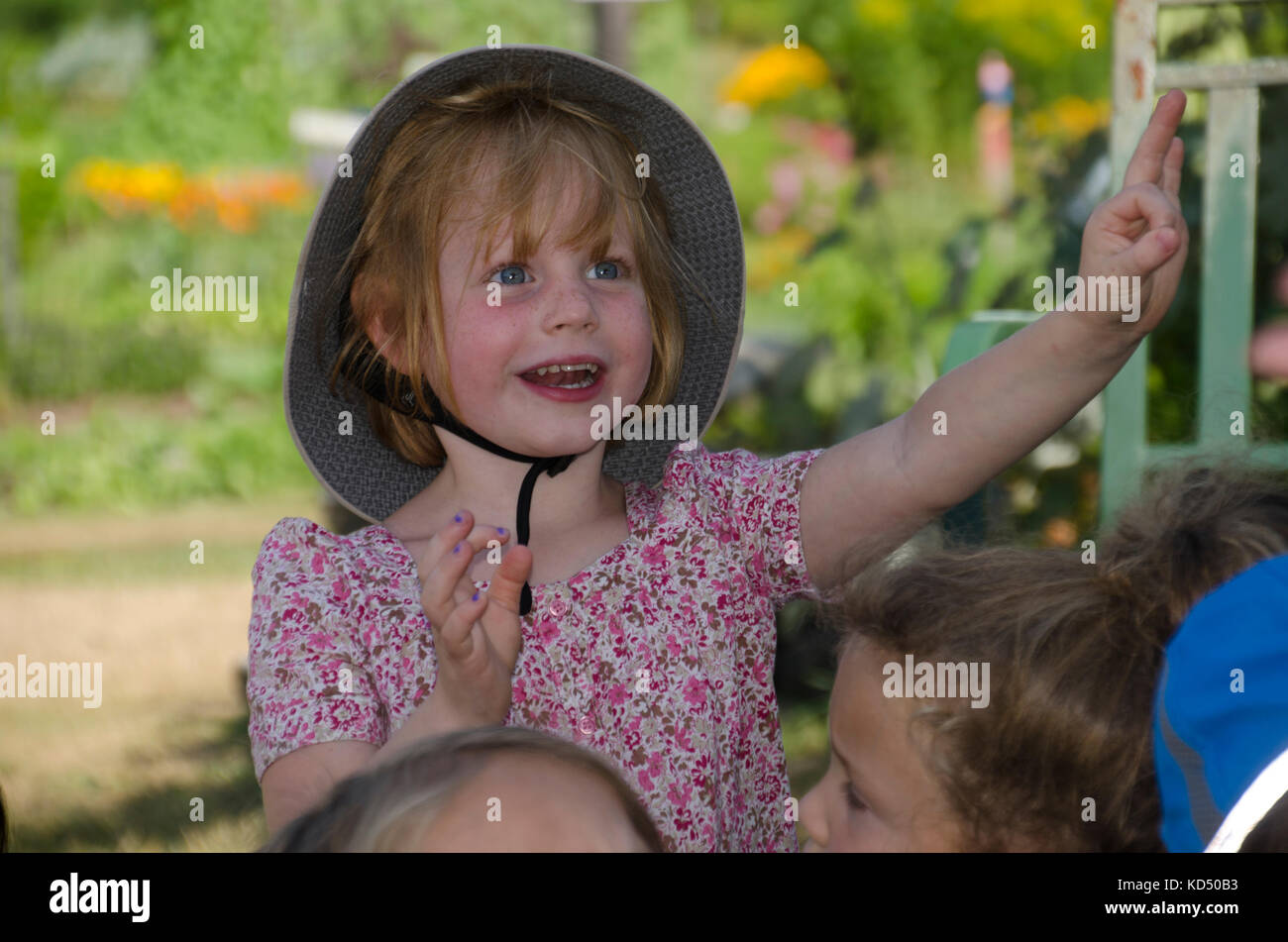 Young girl at garden camp participating in a music group, Community Garden, Maine, USA Stock Photo