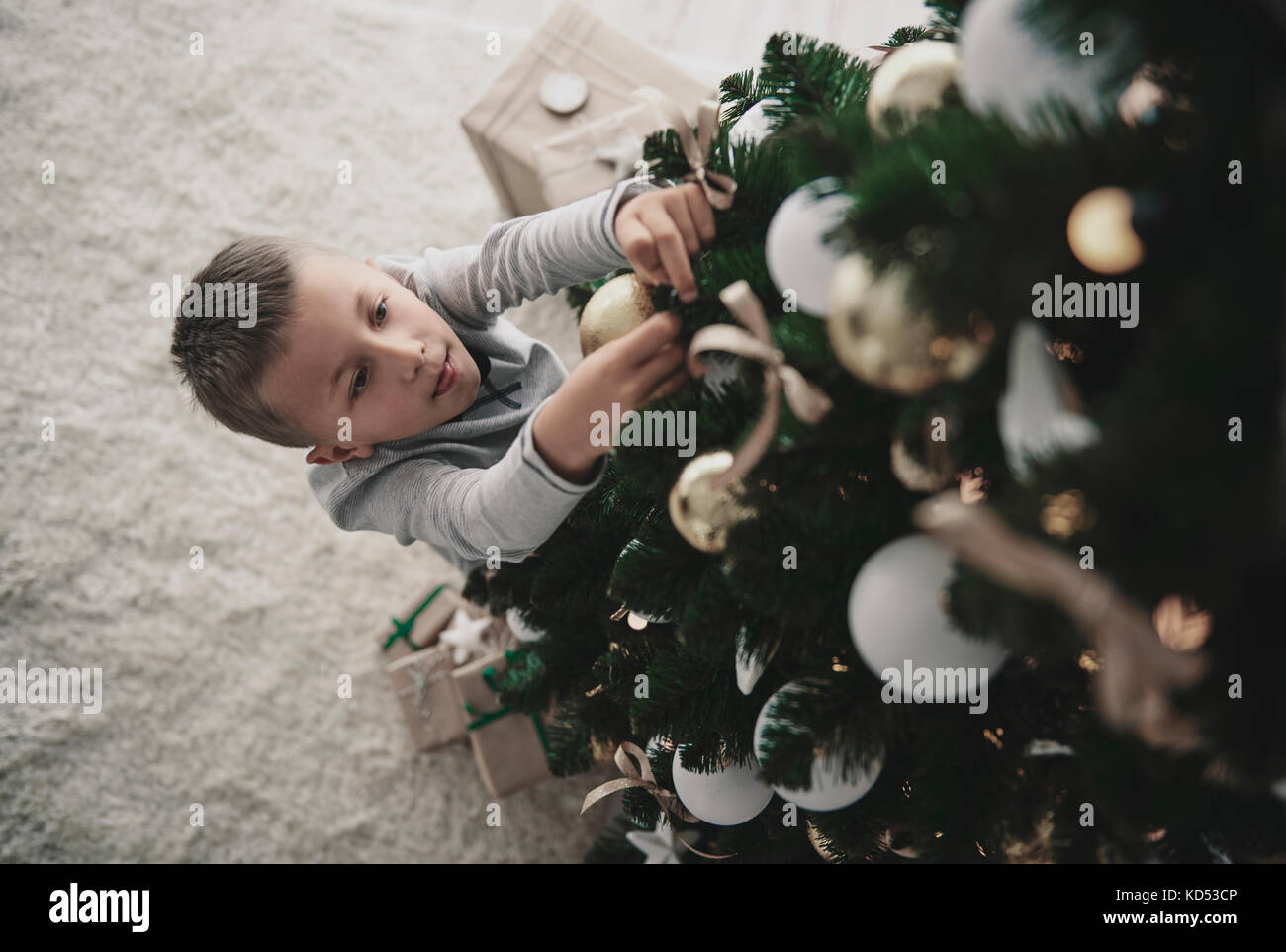 Boy decorating a christmas tree Stock Photo