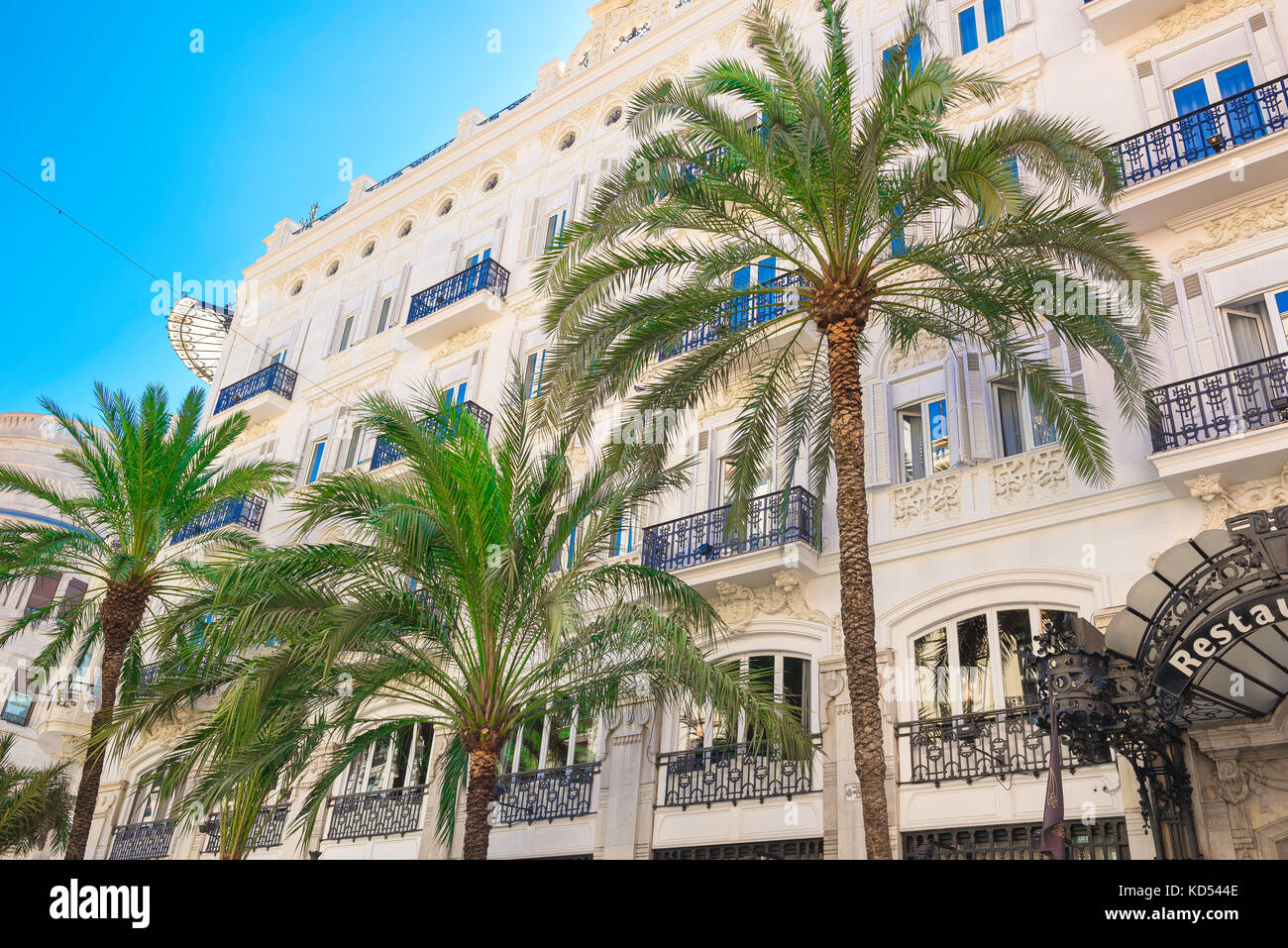 Mediterranean city street, view of the Hotel Reina Victoria in the palm tree lined Calle las Barcas in the center of Valencia, Spain. Stock Photo
