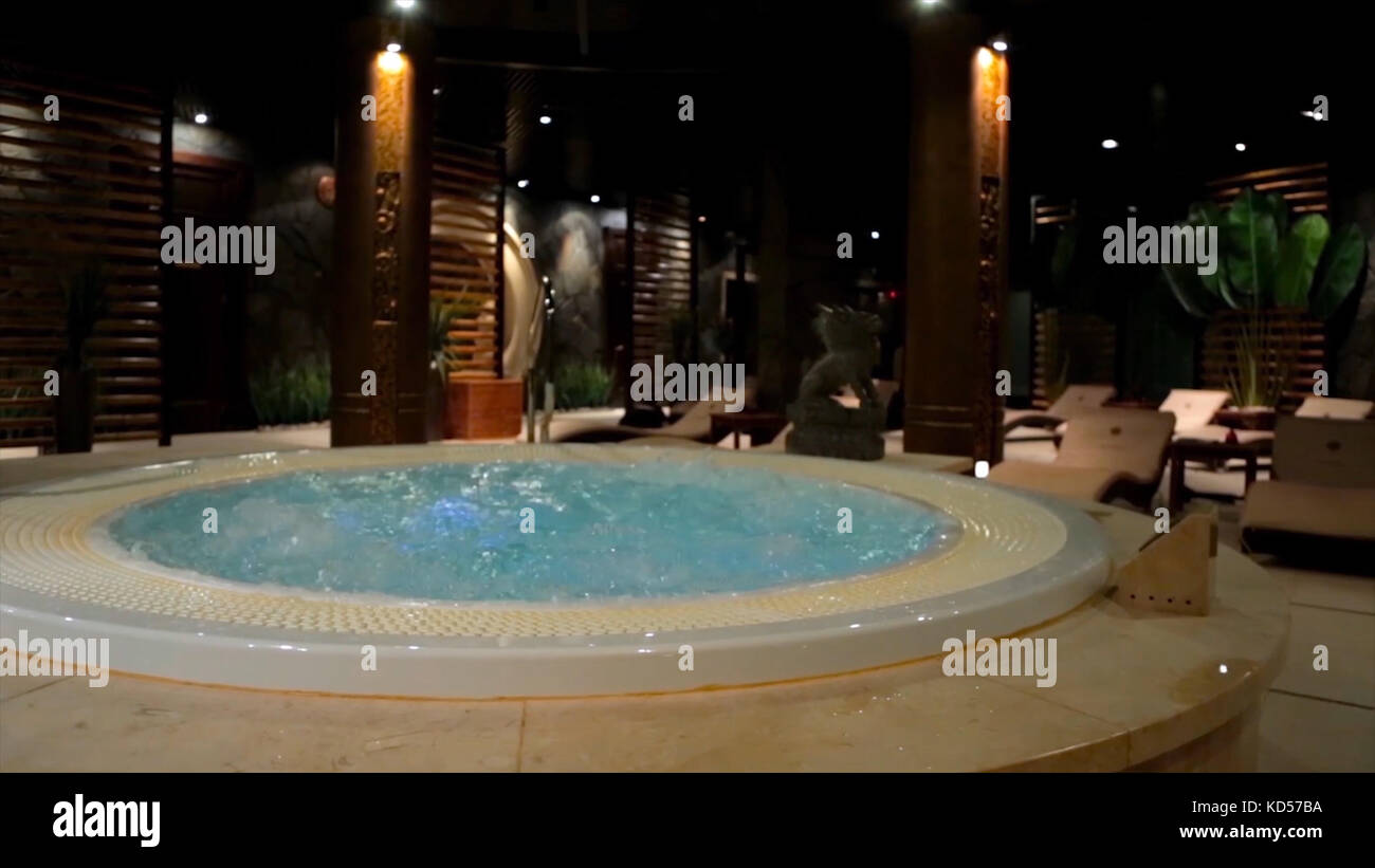 Relaxation pool in spa with waterfall. Empty luxury spa with jacuzzi