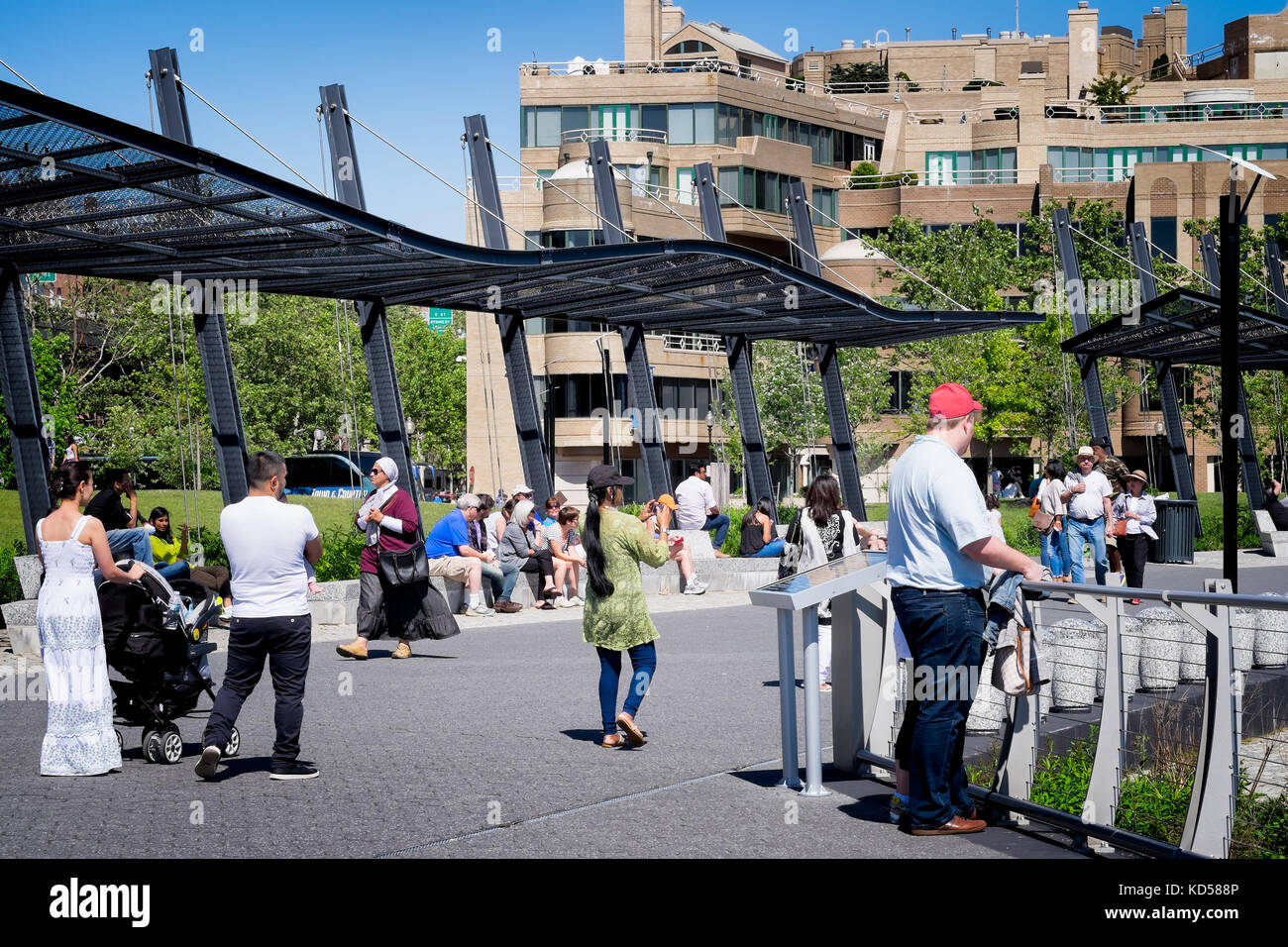 People walking along the Georgetown Waterfront Park, a recently completed national park on the Potomac River in Washington DC. Summer family activity Stock Photo