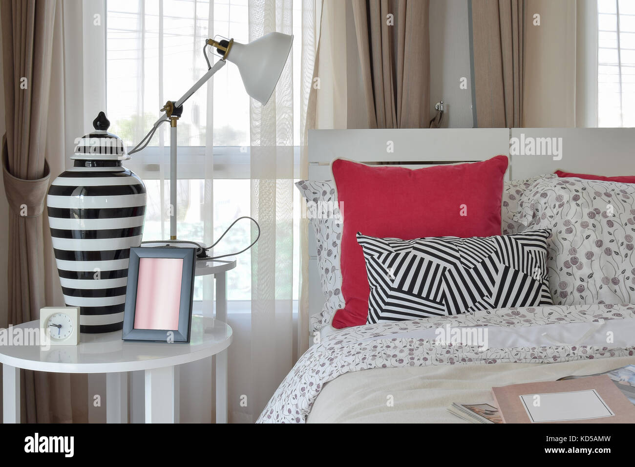 stylish bedroom interior with flower pattern pillows and decorative ...