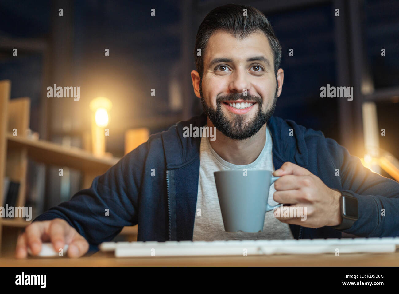 Positive delighted male enjoying his work Stock Photo - Alamy