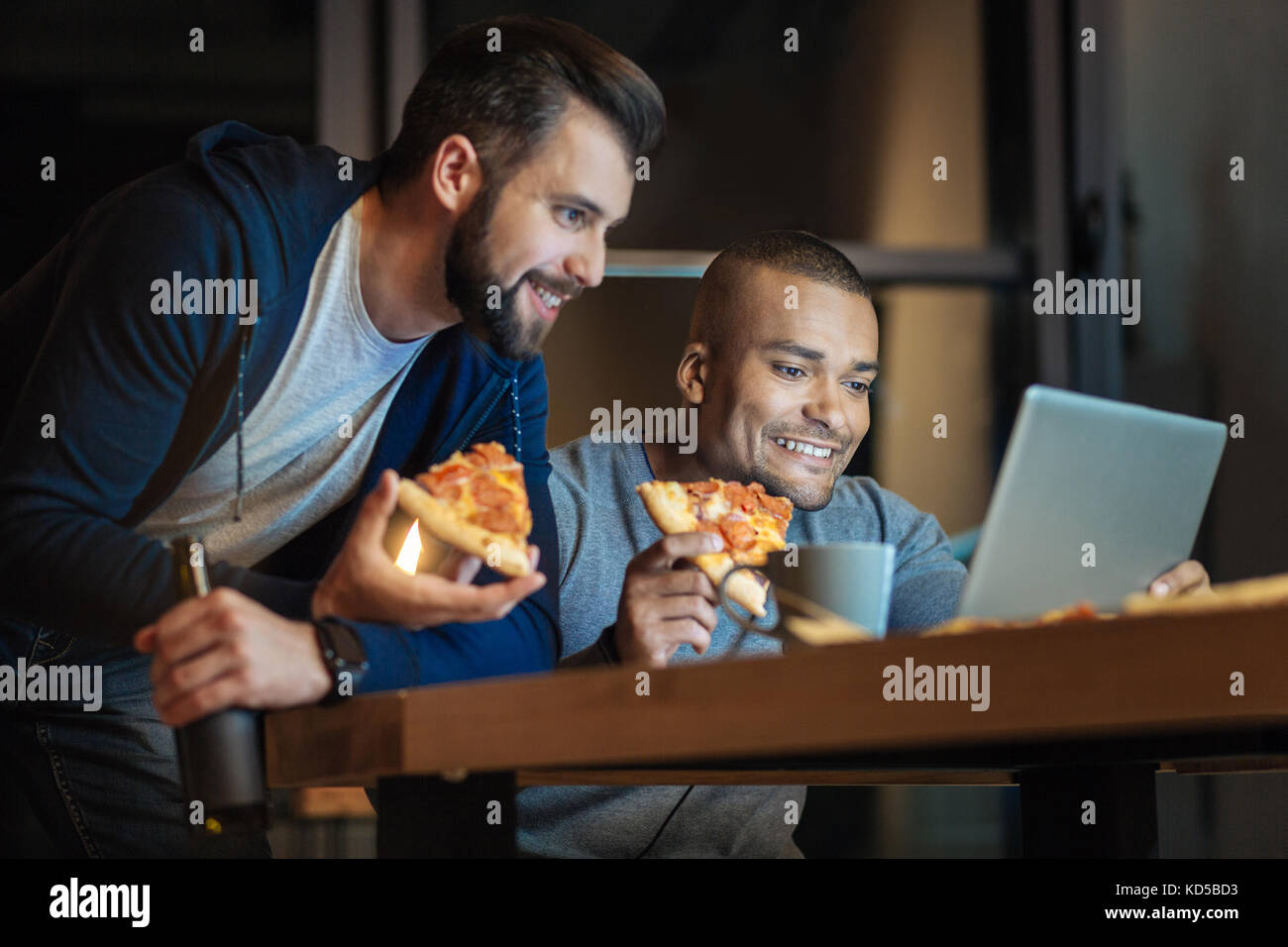 Cheerful people having late supper Stock Photo Alamy