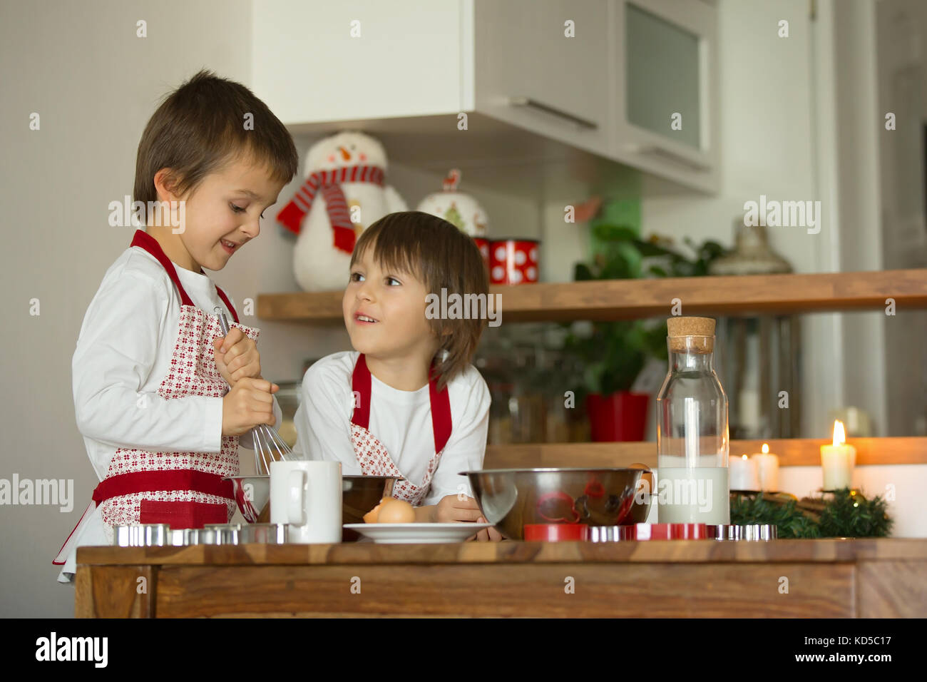 Two Sweet Children Boy Brothers Preparing Gingerbread Cookies For two-sweet-children-boy-brothers-preparing-gingerbread-cookies-for