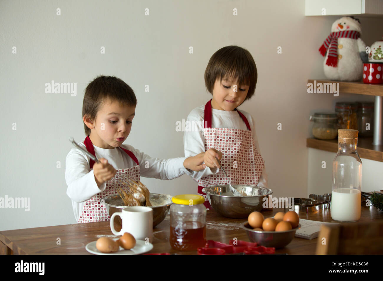 Two Sweet Children Boy Brothers Preparing Gingerbread Cookies For two-sweet-children-boy-brothers-preparing-gingerbread-cookies-for