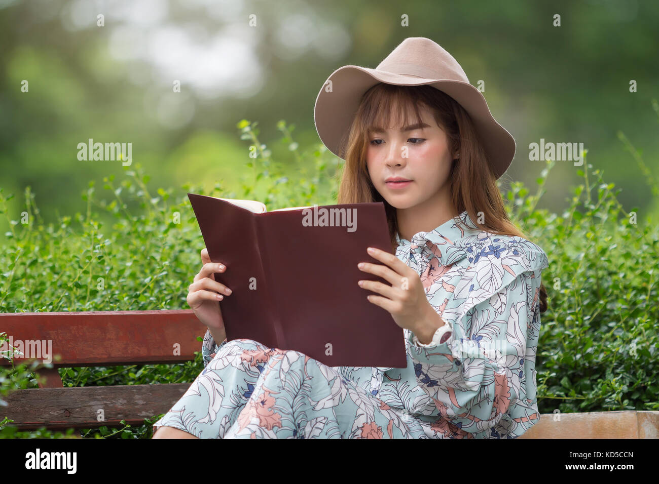 Beautiful asian woman relaxing by reading book in park Stock Photo - Alamy