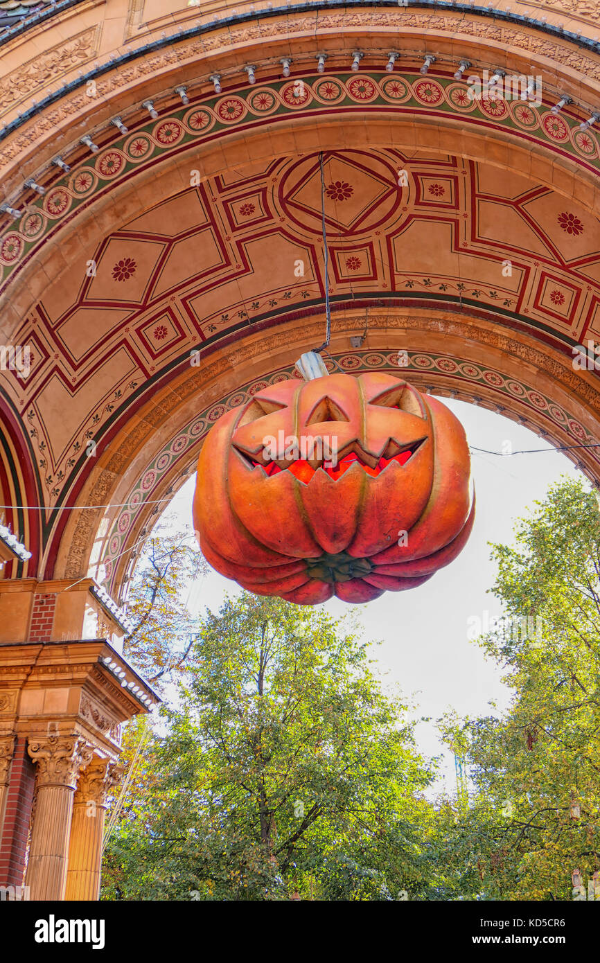Halloween pumpkin hanging from an arched entrance Stock Photo