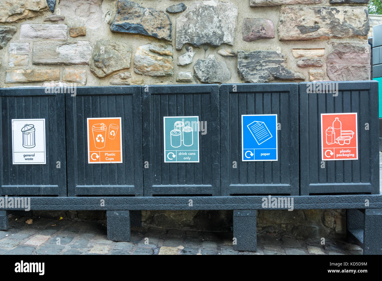 Five black garbage bins as seen from the front Stock Photo Alamy