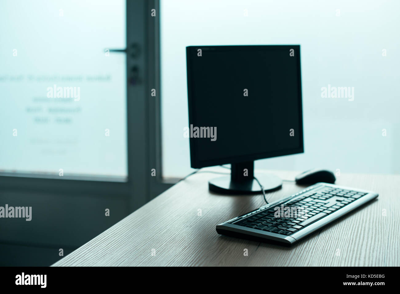 Desktop PC computer in empty office, closing small business and entrepreneurship background Stock Photo
