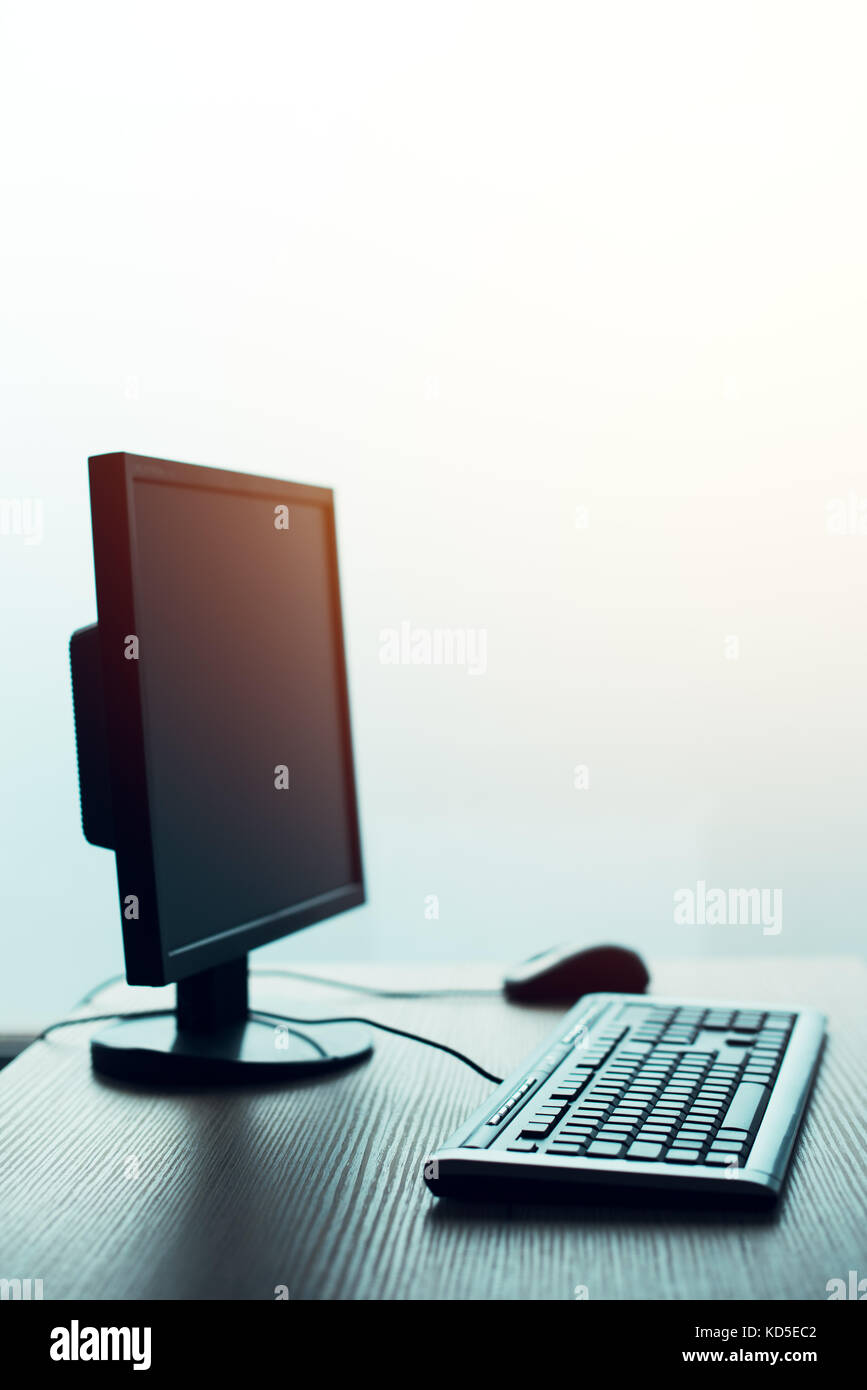 Desktop PC computer in empty office, closing small business and entrepreneurship background Stock Photo