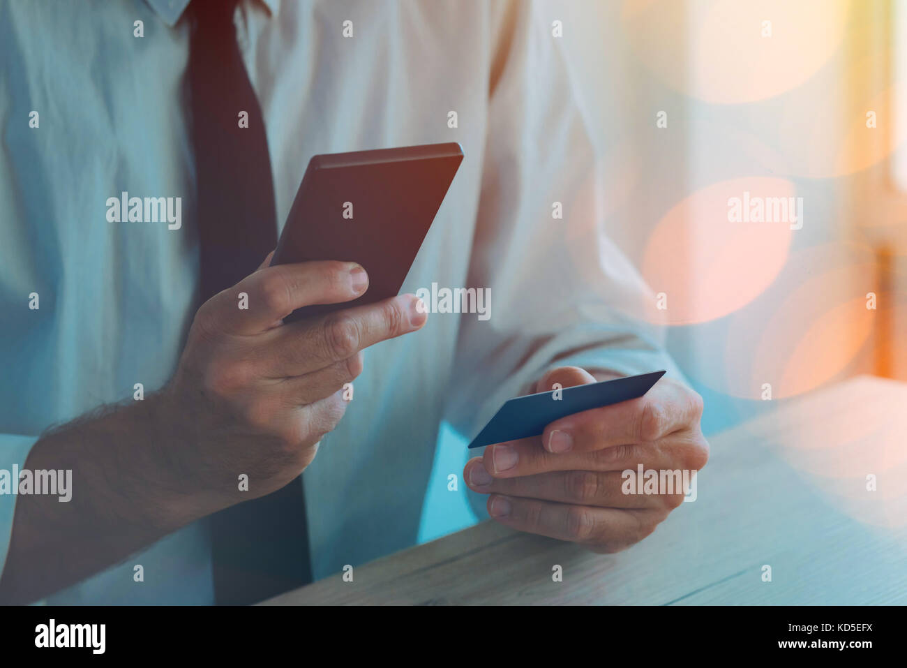 Credit card and mobile payment. Man using smartphone app to make an online bank transaction. Paying and buying on the internet with electronic banking Stock Photo