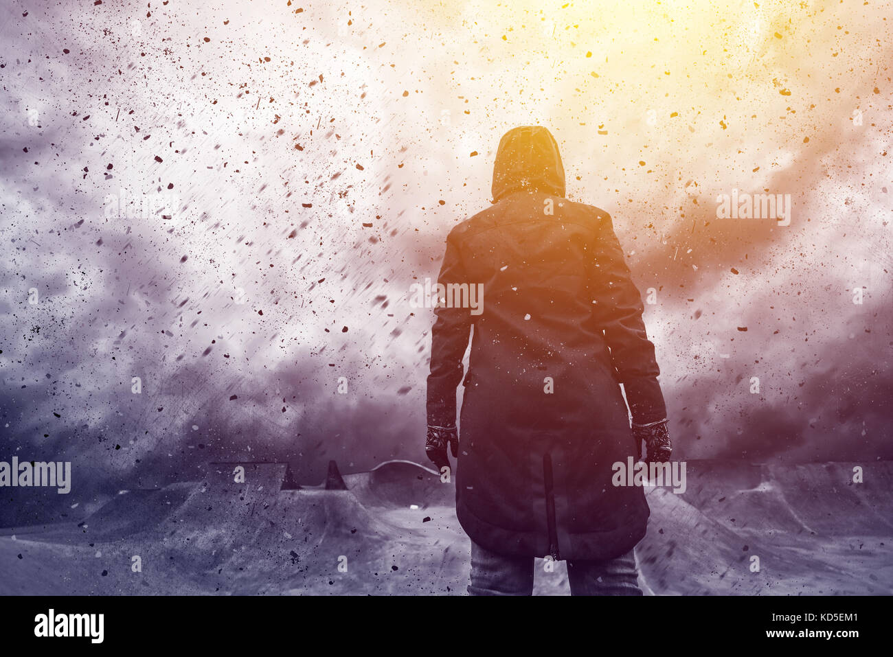 Conceptual image of young female person facing uncertain future, mixed media content with dramatic stormy clouds in background Stock Photo