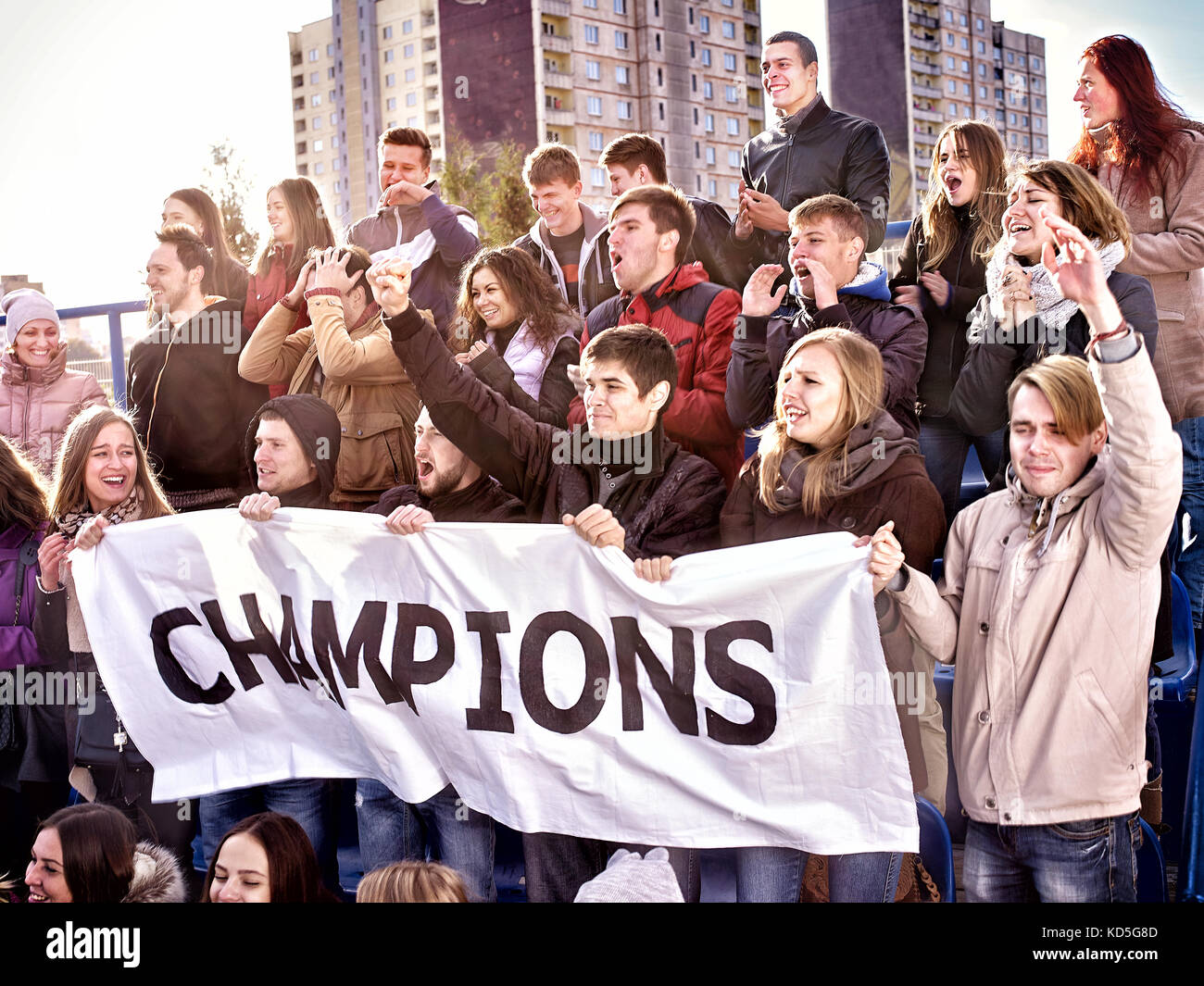 Cheering fans in stadium holding champion banner Stock Photo Alamy
