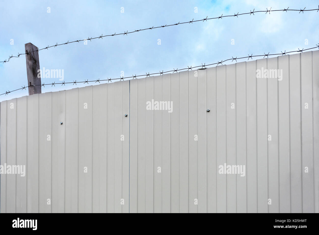 Barbed wire against the blue sky Stock Photo - Alamy