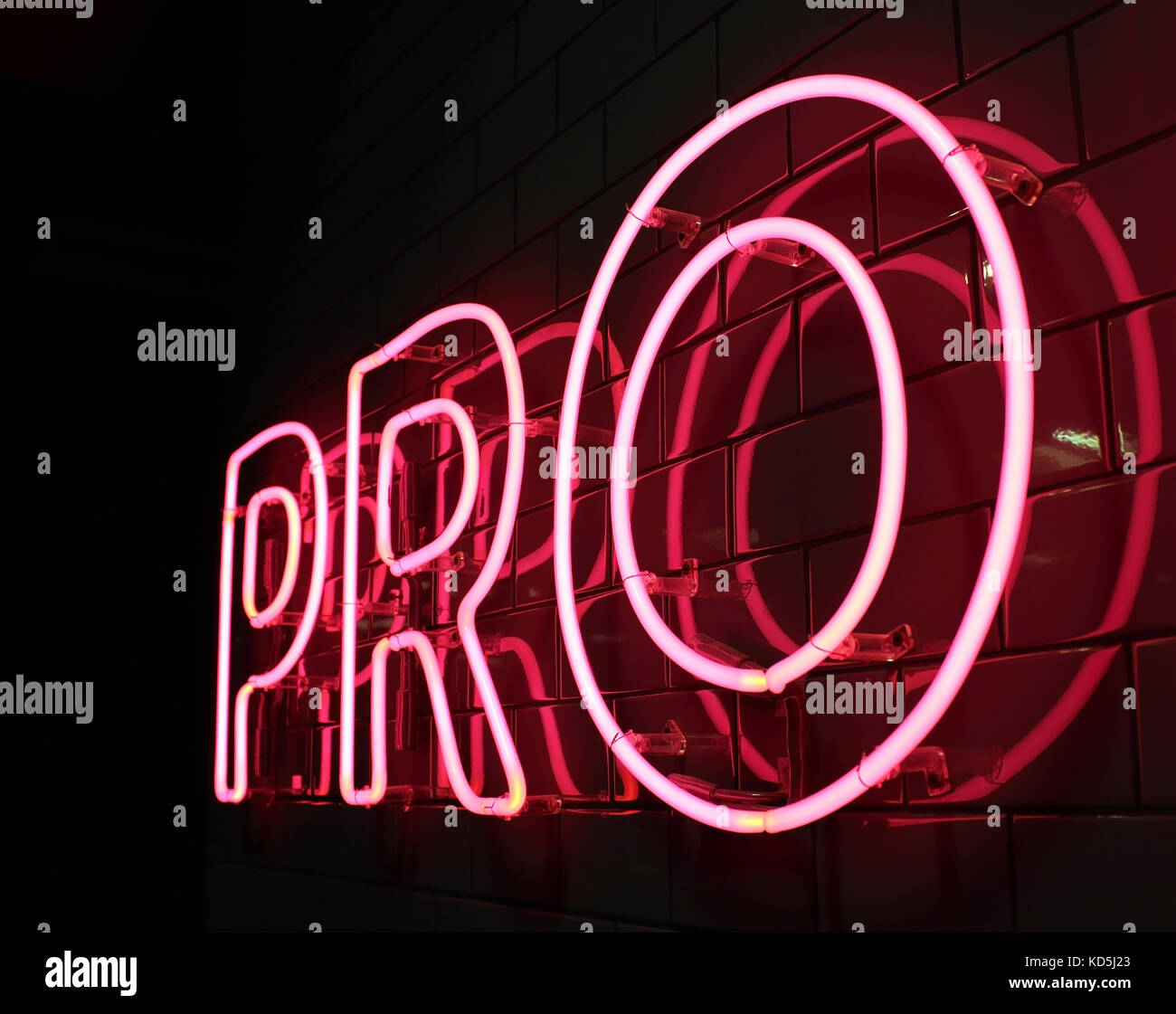 Pro red neon light letters on a black background Stock Photo