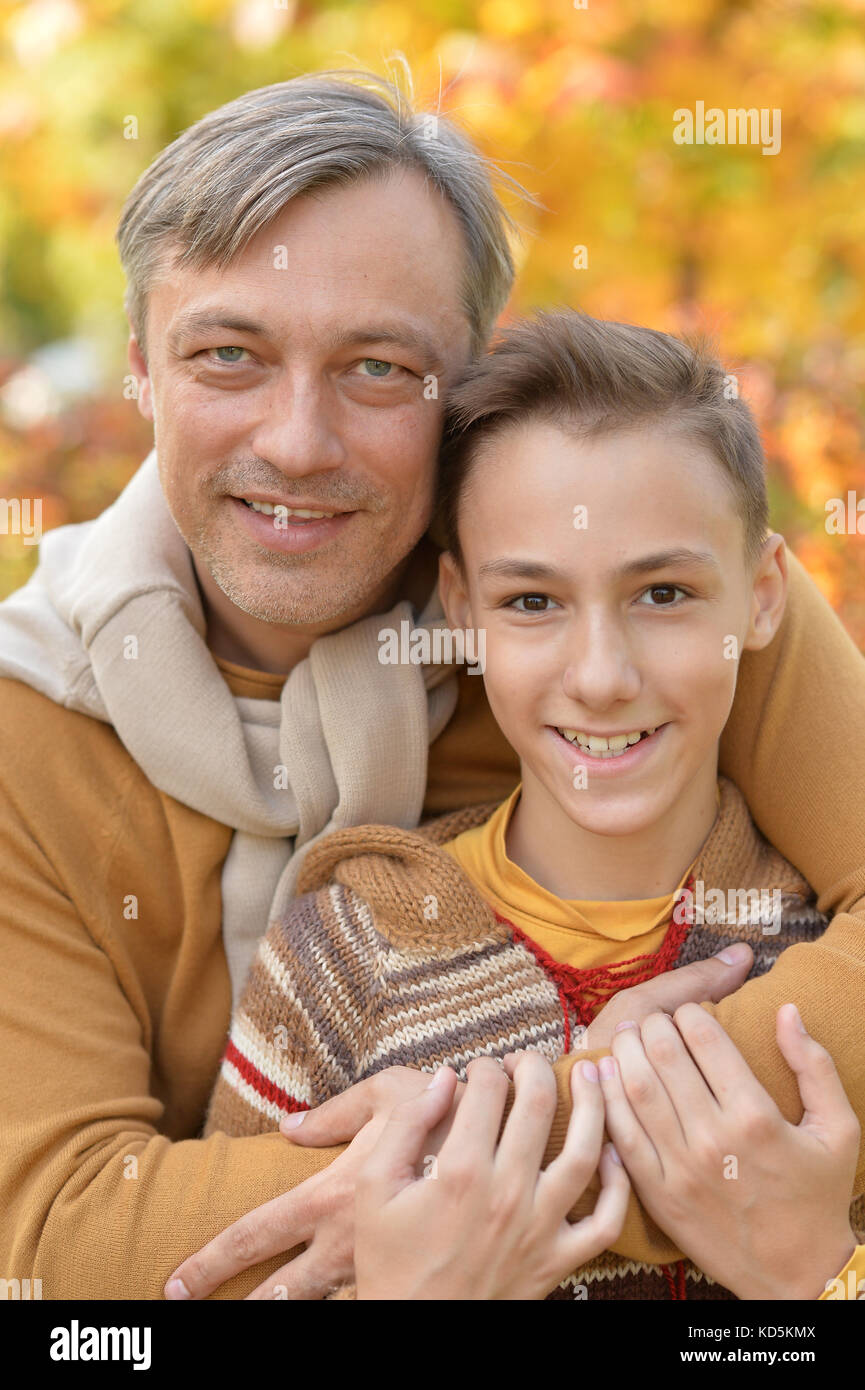 Father and son in autumn park Stock Photo - Alamy