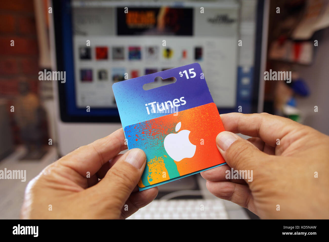 View on Apple Itunes and App Store Gift Voucher Card Hold by Hand