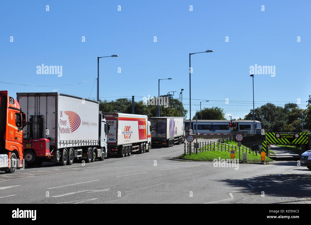 Lorries queued up at the railway level crossing, Ely, Cambridgeshire, England, UK Stock Photo