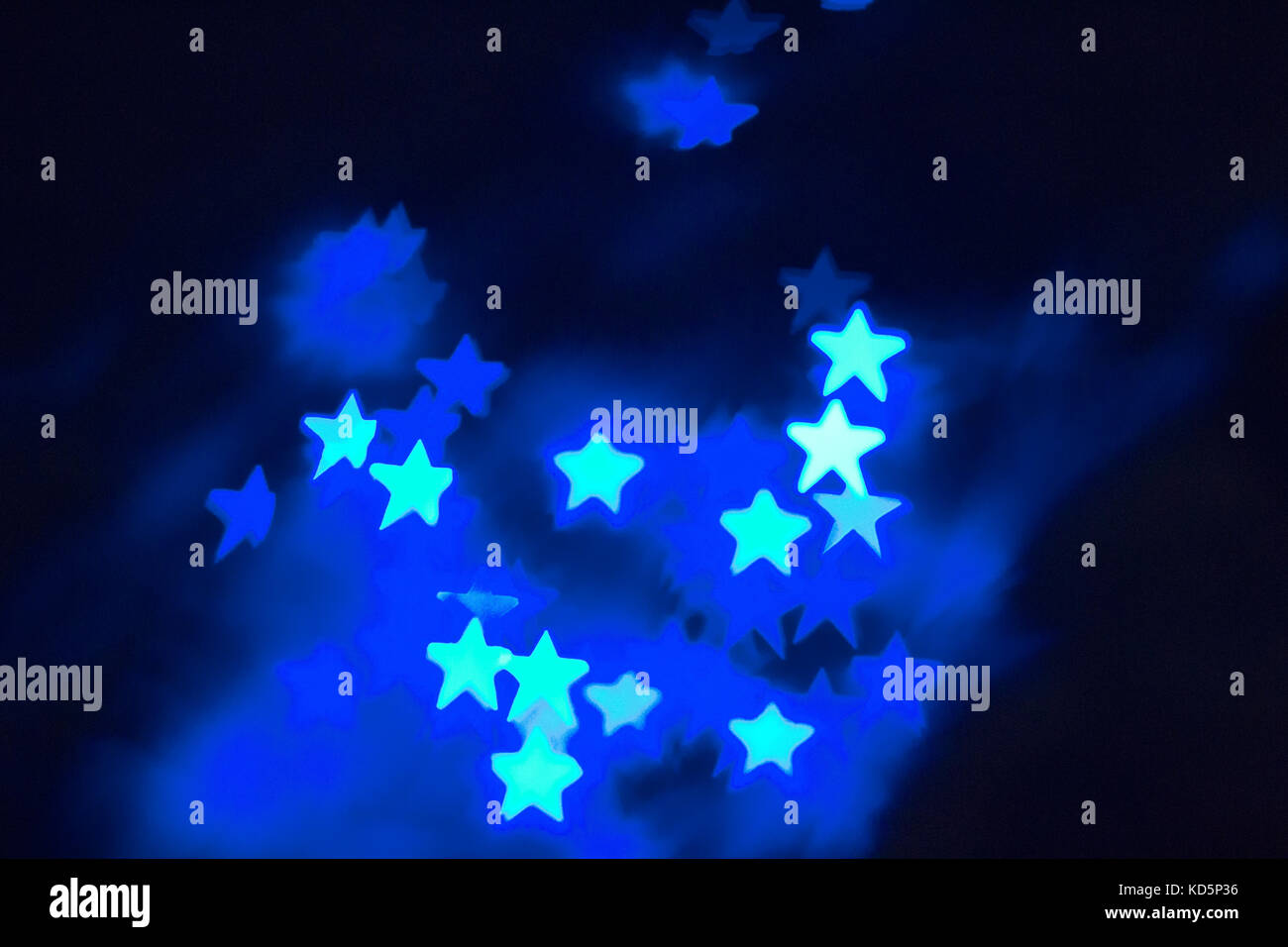 abstract background with star shaped bright blue bokeh and space Stock Photo