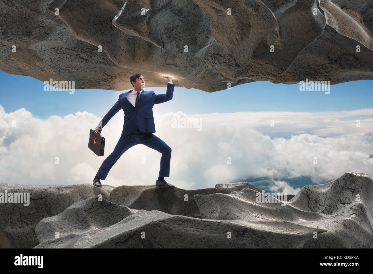 Businessman supporting stone under pressure Stock Photo - Alamy
