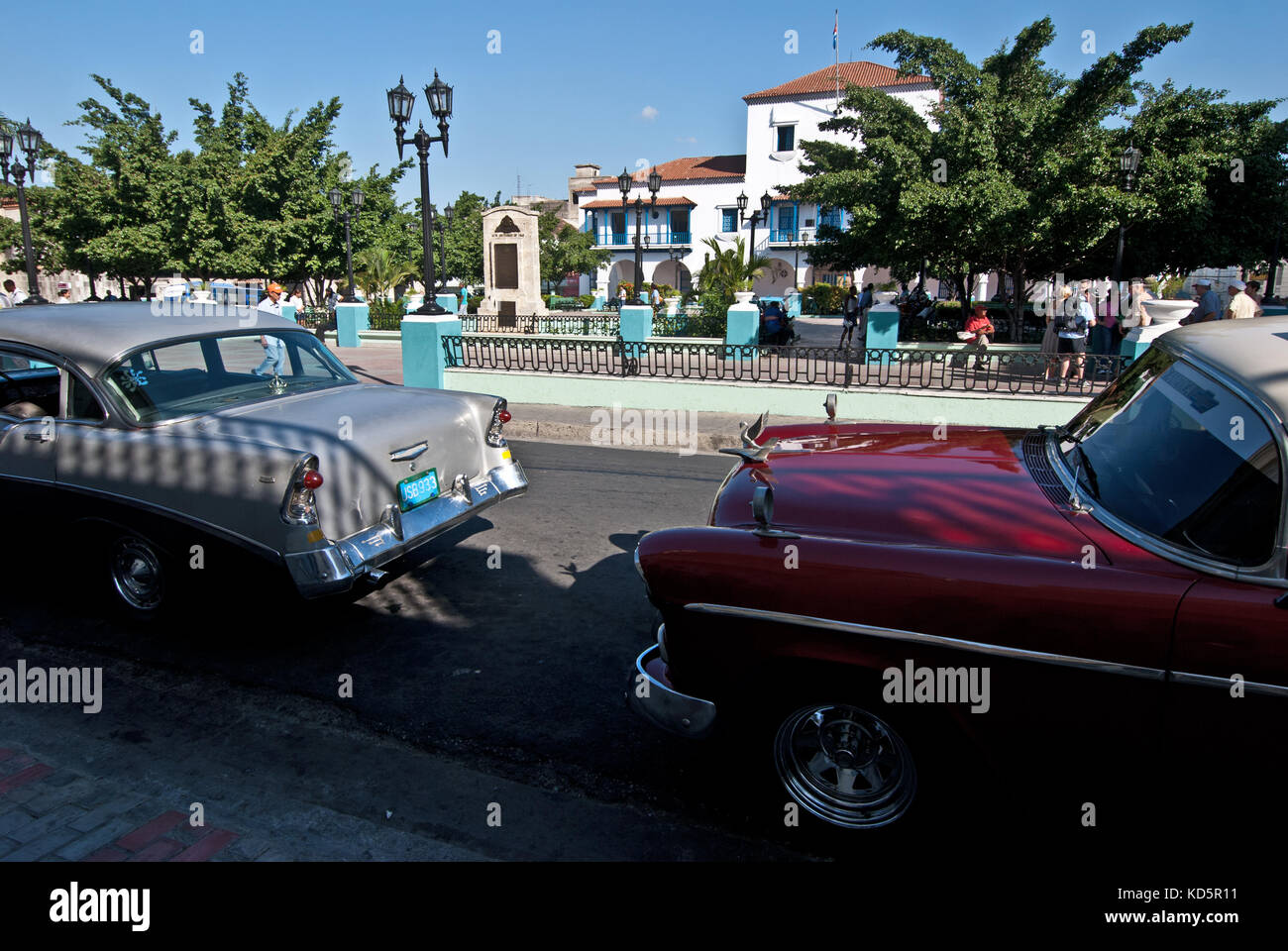 Oldtimer cars parked along town square in Santjage de Cuba, Cuba Stock Photo