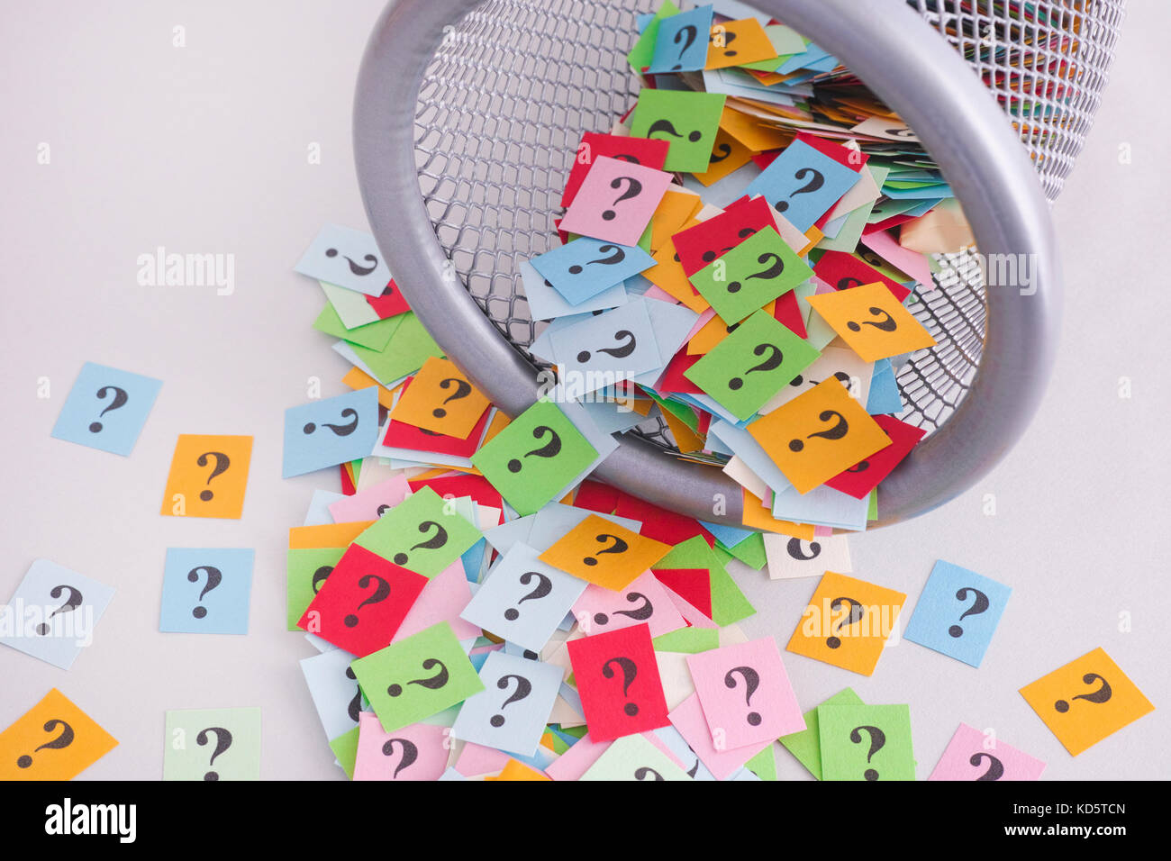 Colorful question marks falling out of trash can. Close up Stock Photo