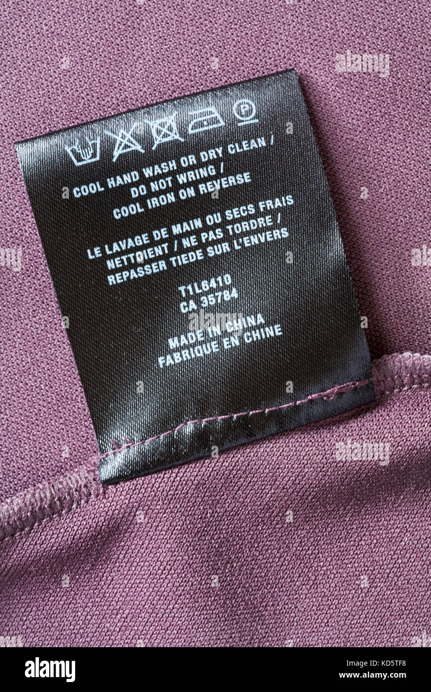Care washing symbols and instructions on label in womans dress made in ...