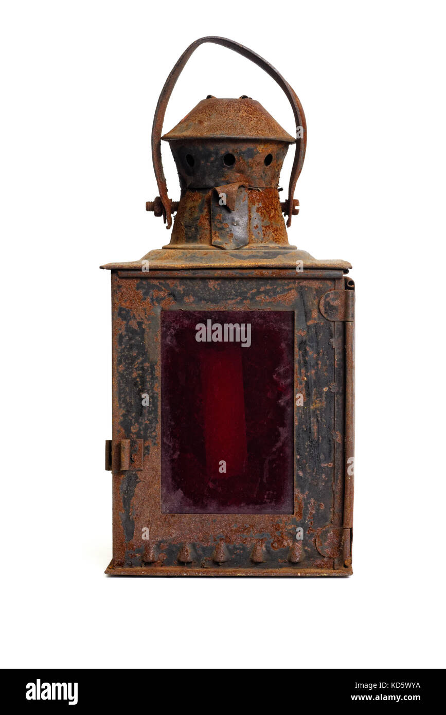 Isolated objects: very old shabby and rusty lantern, with red glass, on white background Stock Photo