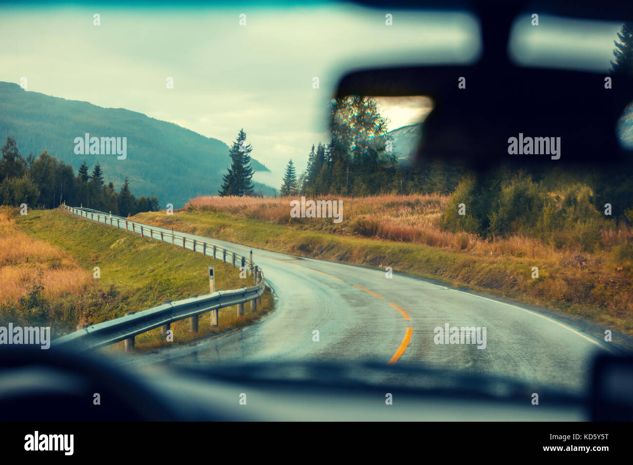 Driving a car on the mountain road. Road among mountains with the ...