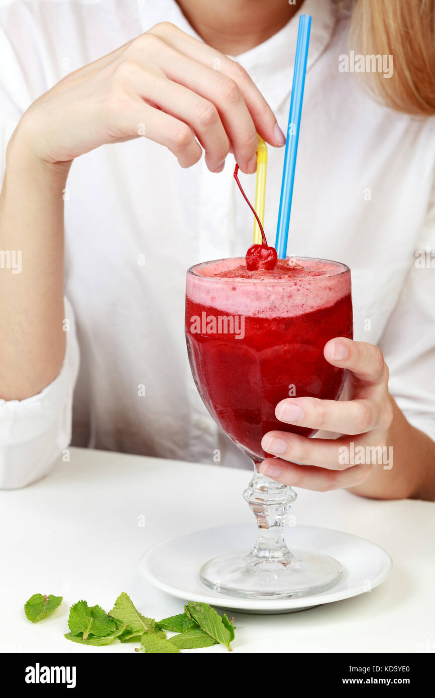 https://c8.alamy.com/comp/KD5YE0/cherry-smoothie-in-a-big-glass-cup-with-two-straws-in-womans-hands-KD5YE0.jpg