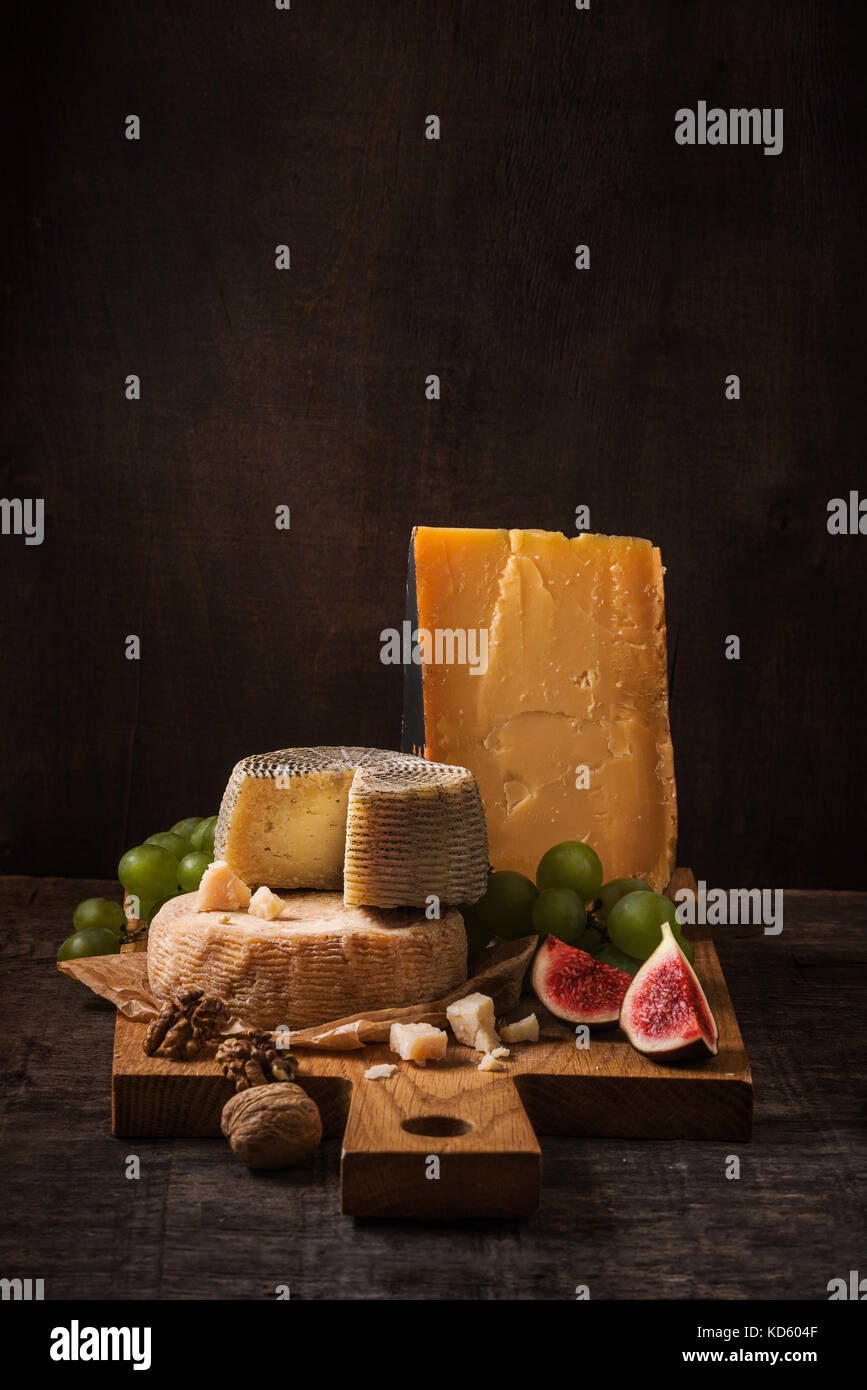 Cheese board, fruits and nuts on the rough wood Stock Photo Alamy