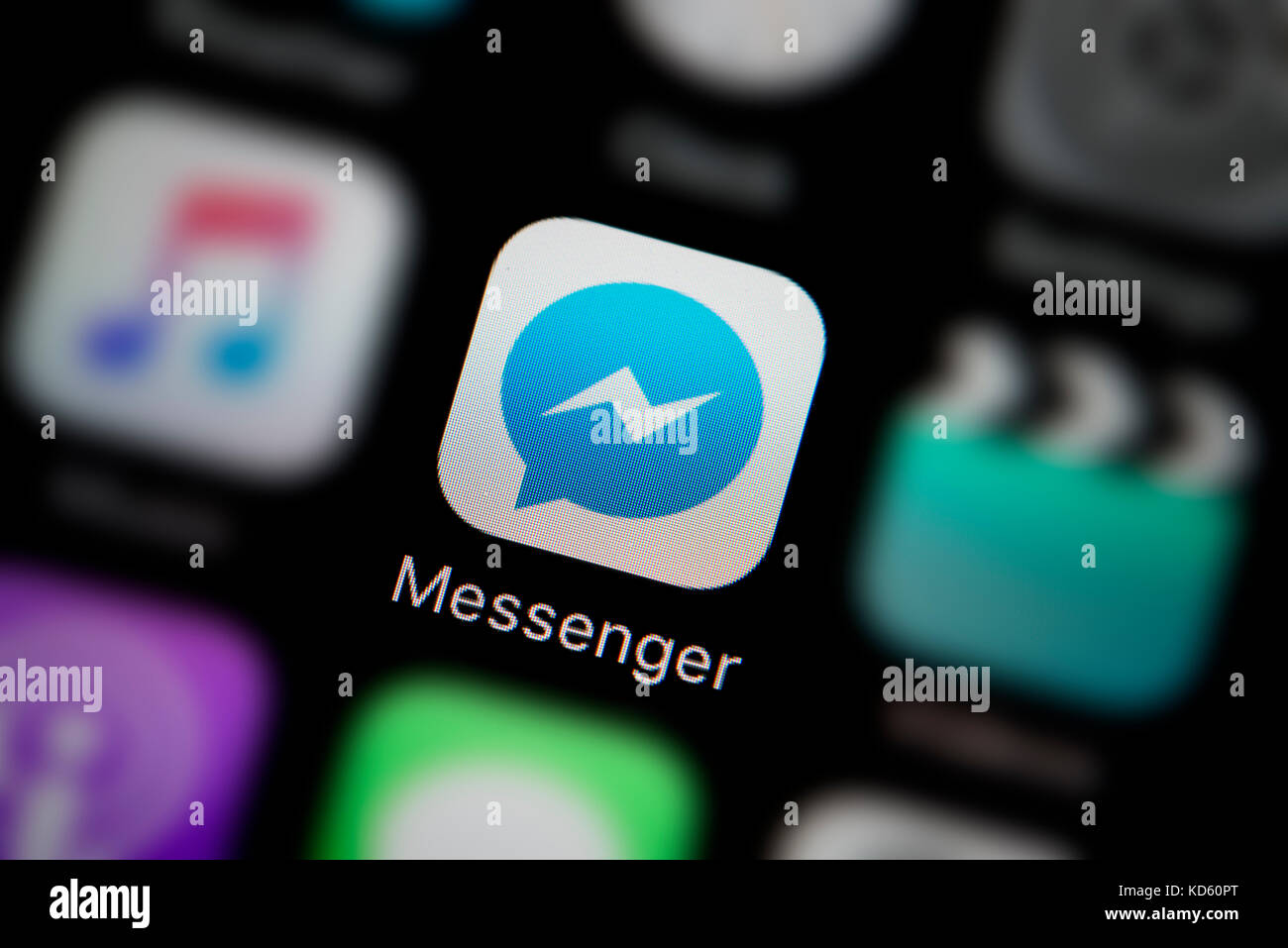 A close-up shot of the company logo representing the Facebook Messenger app icon, as seen on the screen of a smart phone (Editorial use only) Stock Photo
