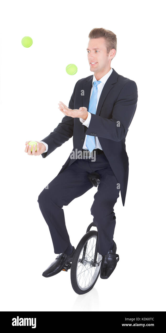 Happy Businessman Juggling Ball Sitting On Unicycle Stock Photo Alamy