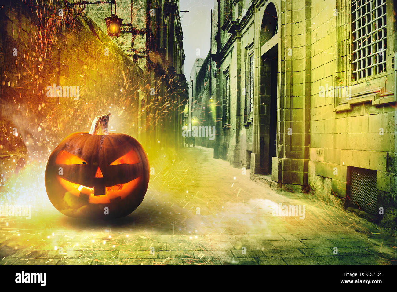 Cold Halloween night in the ancient cobbled street, pumpkin illuminated