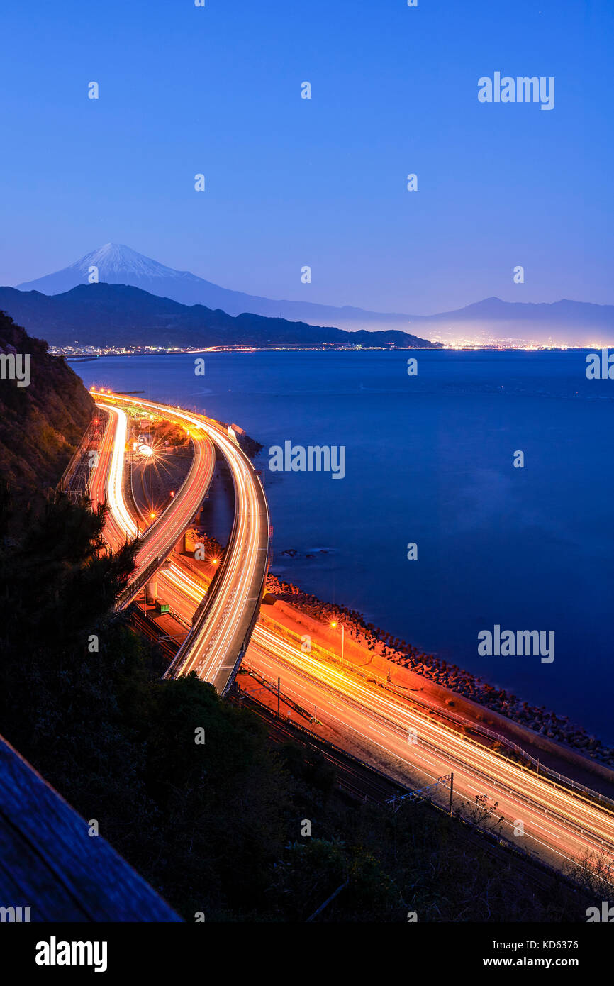 Night view of Mount Fuji and highway from Satta ridge at sunset, Shizuoka Prefecture, Japan Stock Photo