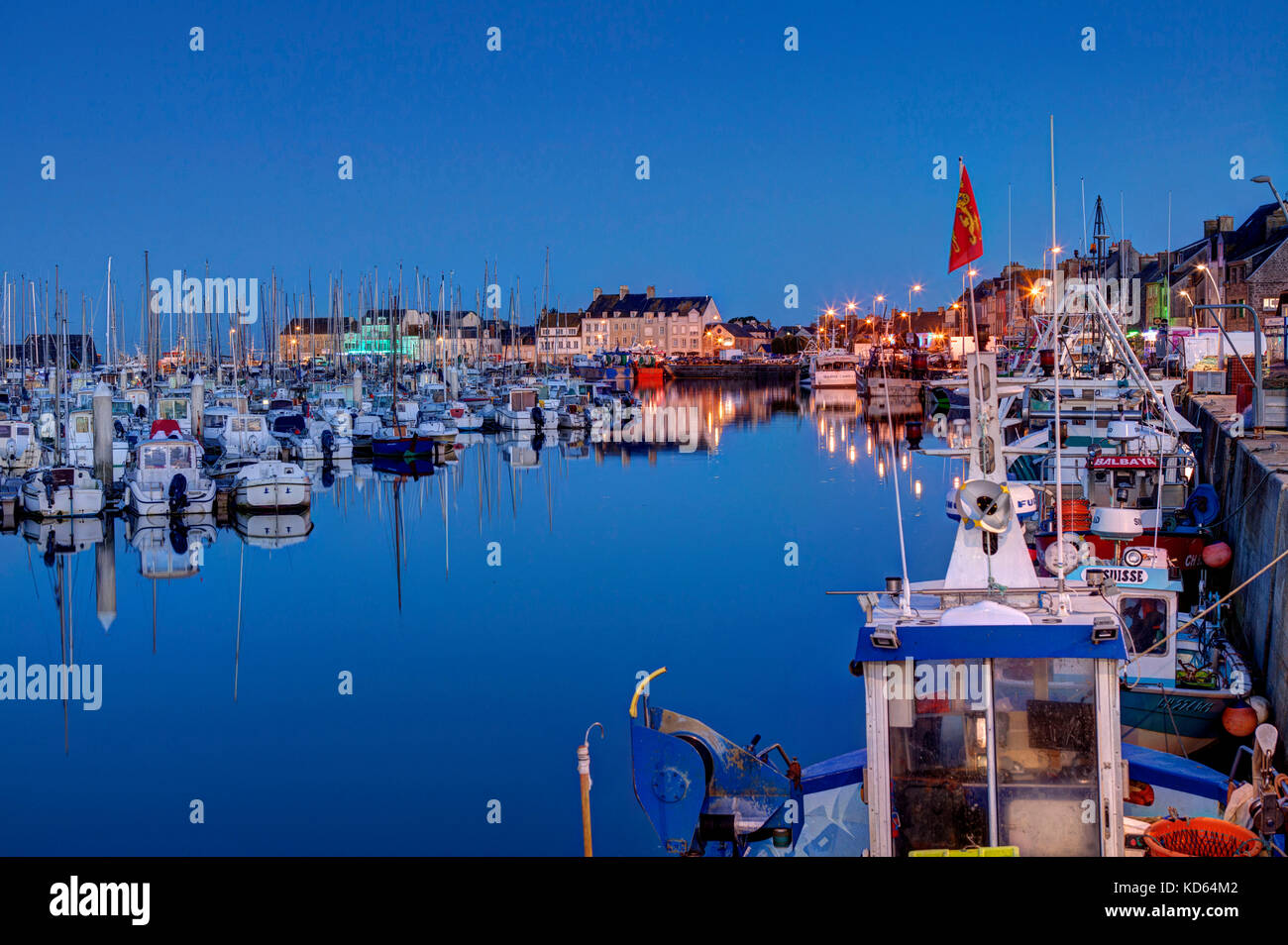 Saint-Vaast-la-Hougue (Normandy, north-western France): night view of the harbour with yachts and fishing boats alongside the quay (not available for  Stock Photo
